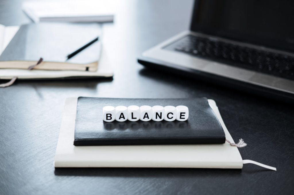 Balance in Accounting. Word Balance on background of laptop and calculator in office.